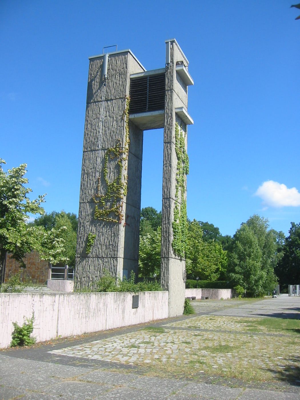 Close view of the bell tower covered in climbing plants at Gatow Landscape Cemetery